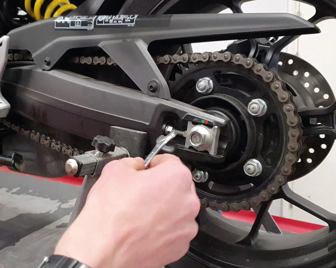 Honda how to tighten your chain - undo locking nuts and adjust chain tension - step two
