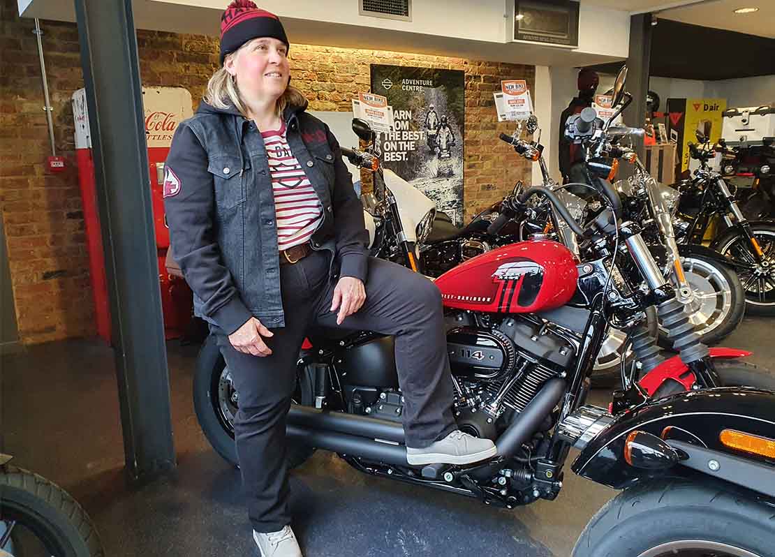 Model leaning on Harley-Davidson Street Bob