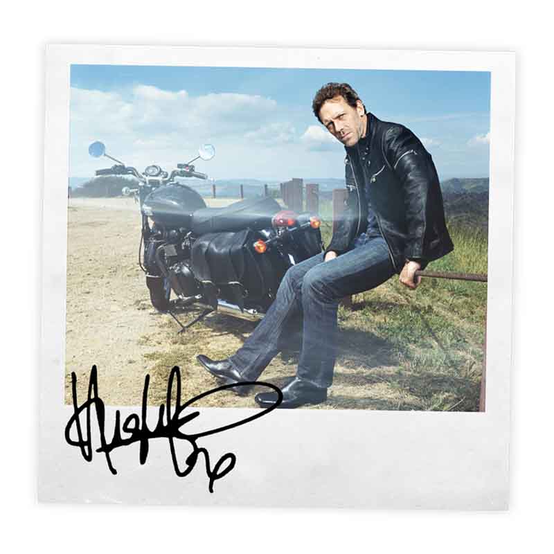 Signed polaroid of Hugh Laurie and his Bonneville T100