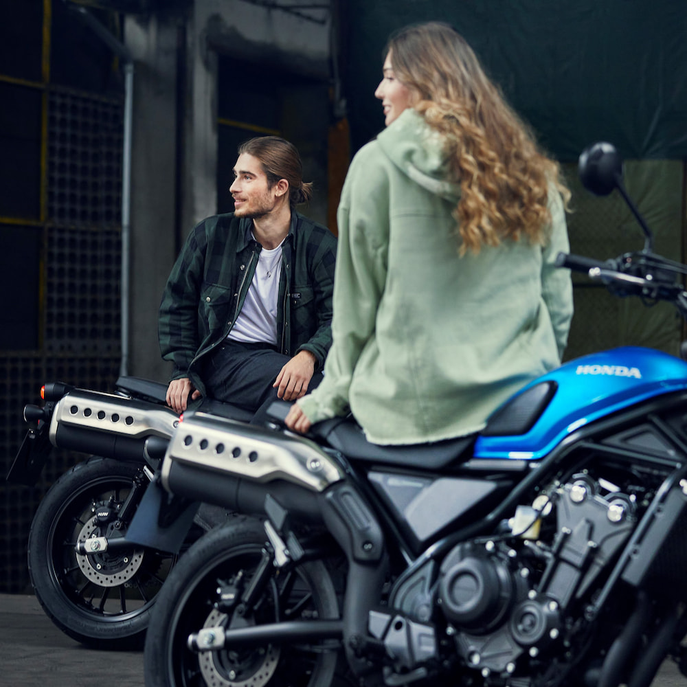 Couple sitting on a Honda motorcycle